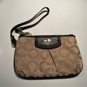 Coach Brown and Tan Wristlet.   Rose color interior. Leather strap.